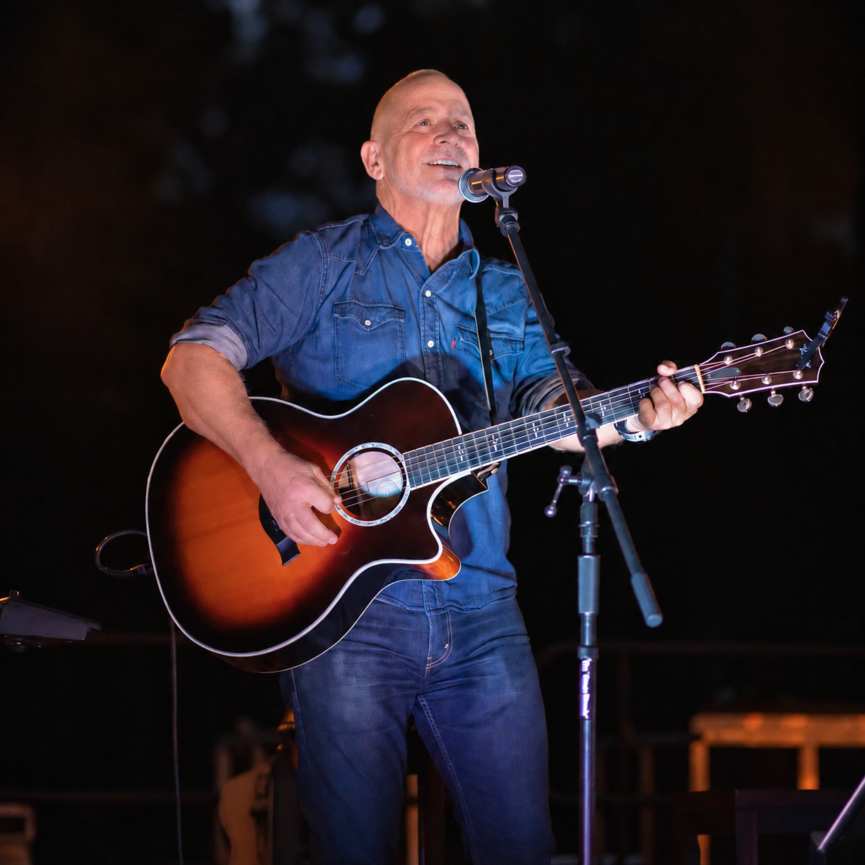 Danny Dukes singing and playing his acoustic guitar